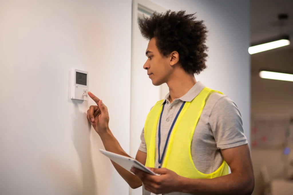 service man checking sensor door locker looking involved