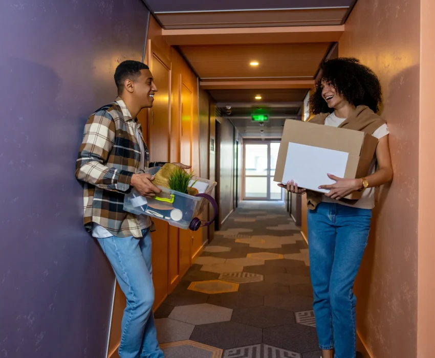 carrying-clothes-young-couple-carrying-their-clothes-hotel-corridor